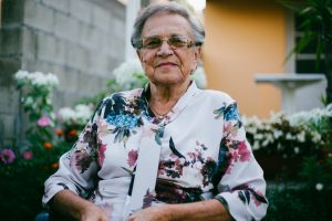 elderly woman in floral shirt