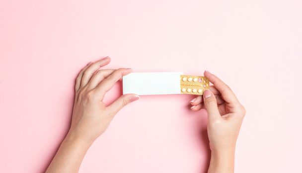 Female,Hands,Holding,Birth,Control,Pills,On,Pink,Background.,Women