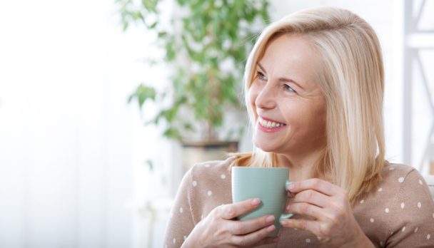 Portrait,Of,Happy,Middle,Aged,Woman,With,Mug,In,Hands