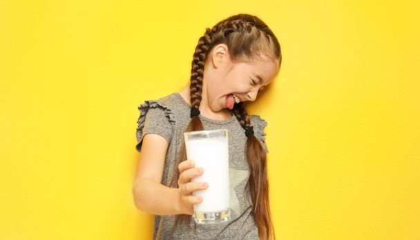 Little,Girl,With,Dairy,Allergy,Holding,Glass,Of,Milk,On