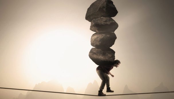 Man,Carries,A,Stack,Of,Big,Rocks,While,Balancing,On