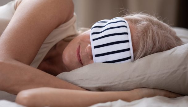 Calm,Mature,Woman,Wearing,Striped,Sleeping,Mask,Relaxing,In,Comfortable