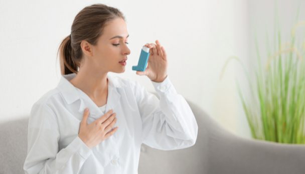 Female,Doctor,With,Inhaler,Having,Asthma,Attack,In,Clinic