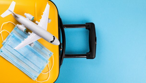 Yellow,Suitcase,With,Traveler,Accessories,On,A,Blue,Background.travel,Concept