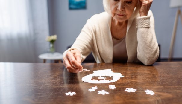 Senior,Woman,Combining,Jigsaw,Puzzle,For,Dementia,Rehabilitation