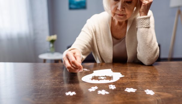 Senior,Woman,Combining,Jigsaw,Puzzle,For,Dementia,Rehabilitation