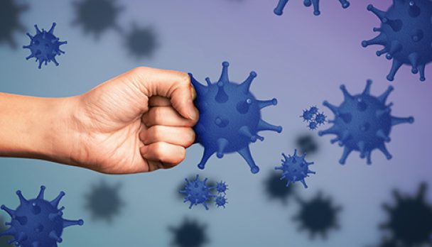 Be healthy - boost your immunity to fight with illness. Man showing clenched fist surrounded by viruses, closeup
