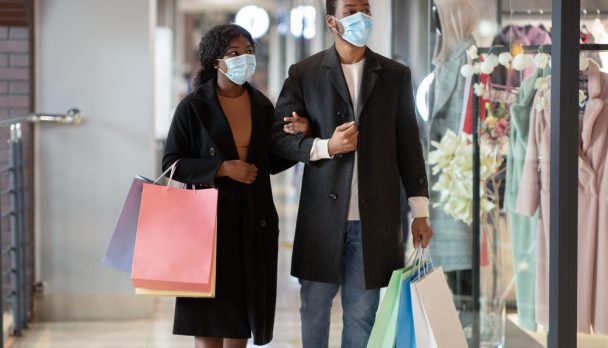 Couple,Walking,Past,Shop,Window,And,Looking,In.,Millennial,African