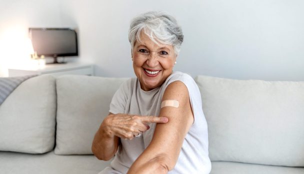 Proud,Mature,Woman,Smile,After,Vaccination,With,Bandage,On,Arm.