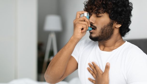 Indian,Guy,Suffering,From,Asthma,,Using,Inhaler,In,Bed,,Side
