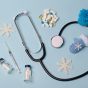 Stethoscope,,Vaccine,,Pills,On,A,Blue,Medical,Background.,The,Concept