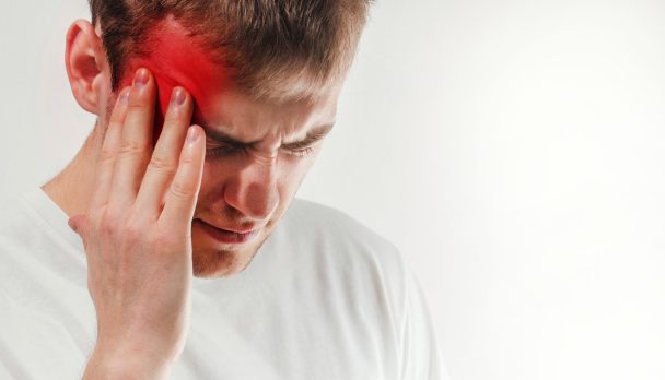 man hold his had and suffering from headache, pain, migraine, sad depressed isolated on white background, in a t shirt